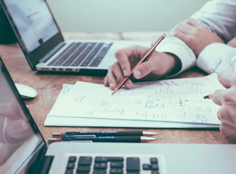 Two people reviewing interview notes together at a desk.